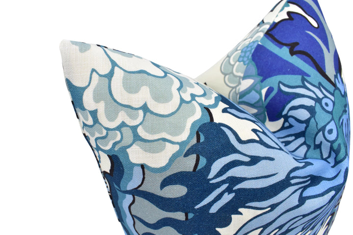 a close-up view of a decorative pillow with a blue and white floral pattern.