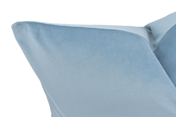a close up of a blue pillow on a white background