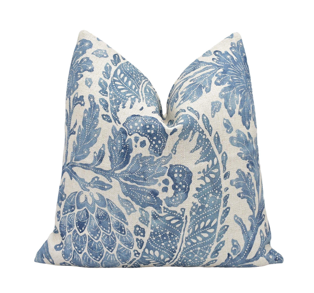 a blue and white pillow on a white background