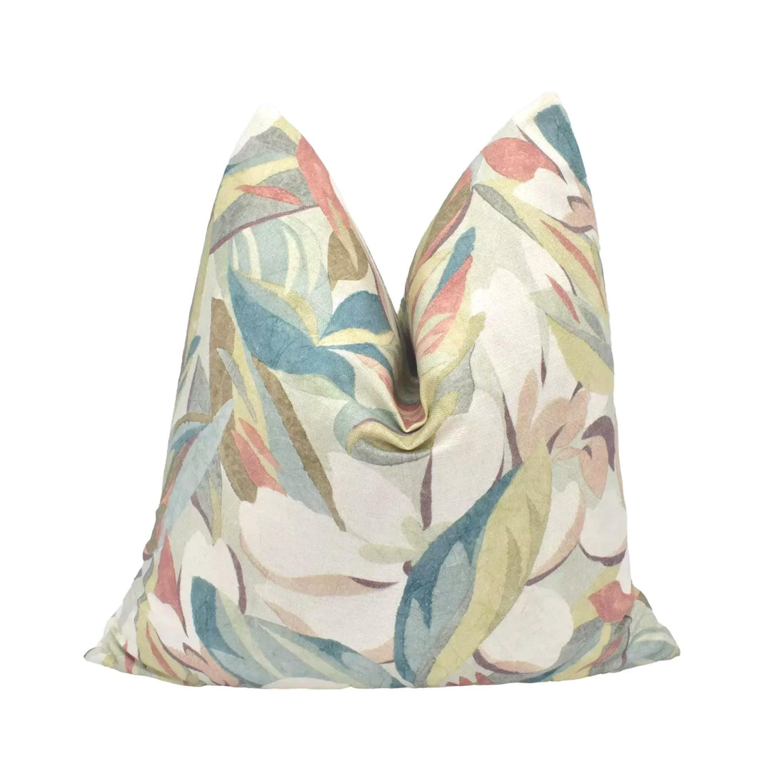 A decorative pillow with a colorful, abstract floral pattern is displayed against a white background.
