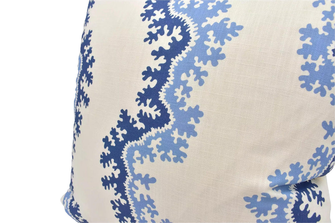 A close-up view of a decorative pillow with a blue and white floral pattern.