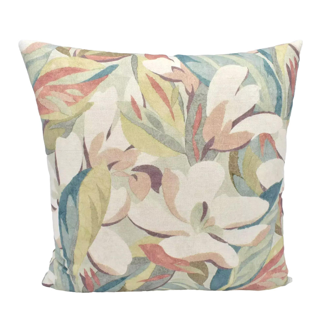 A decorative throw pillow with a floral print in shades of green, pink, and white.