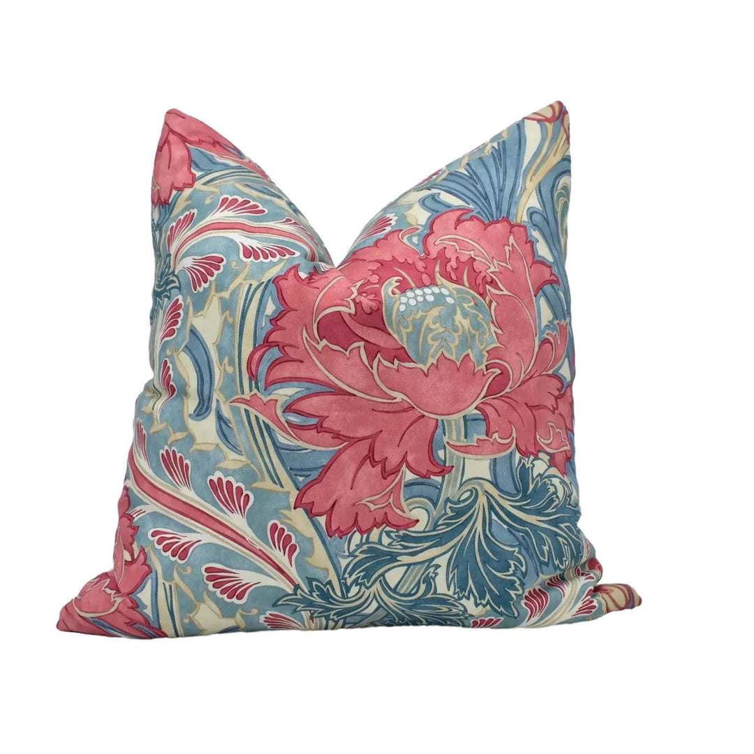 A decorative throw pillow with a vibrant floral pattern in shades of pink, blue, and green.