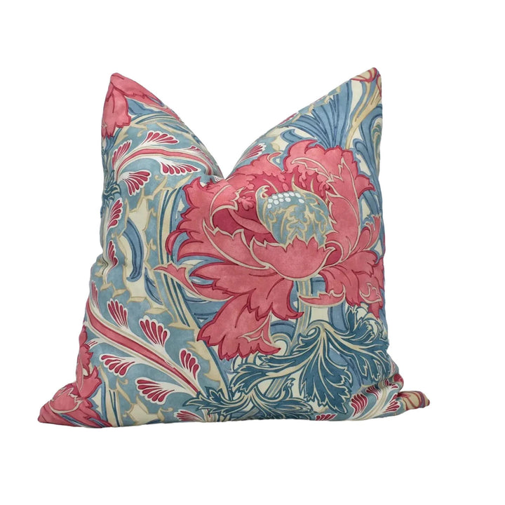 A decorative throw pillow with a vibrant floral pattern in shades of pink, blue, and green.