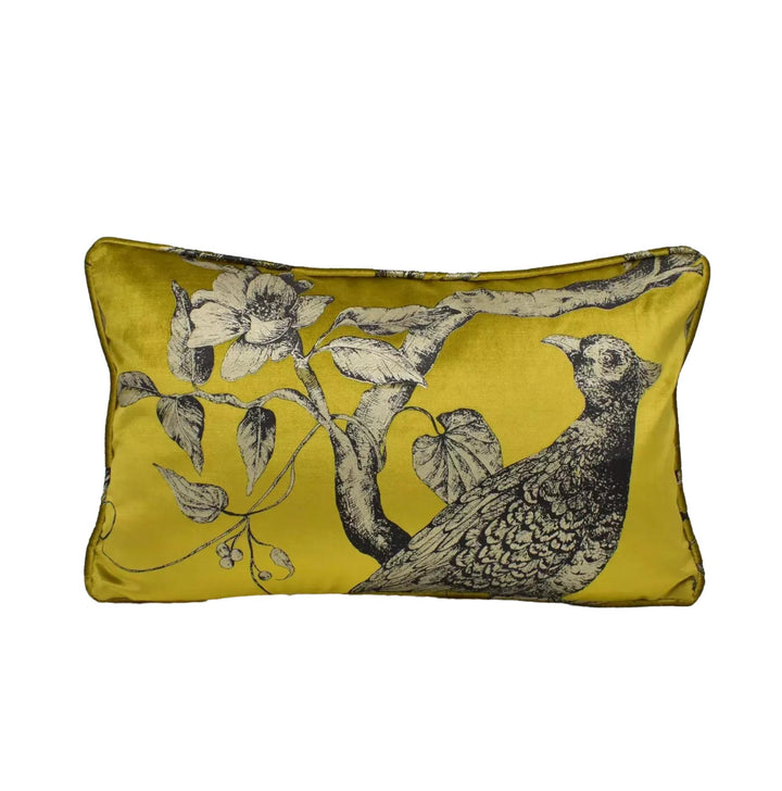 A yellow decorative pillow with a black and white illustration of a bird perched on a branch.