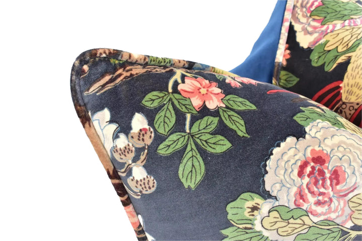 a close-up view of a decorative pillow with a floral pattern in shades of blue, green, and pink.