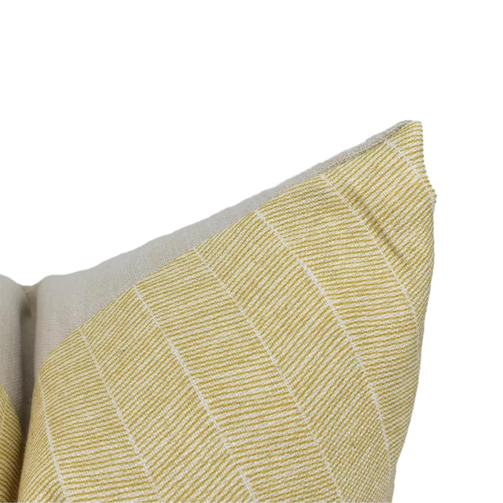 A close-up view of a yellow and white striped pillow against a white background.