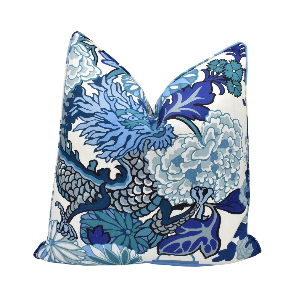 a blue and white pillow on a white background