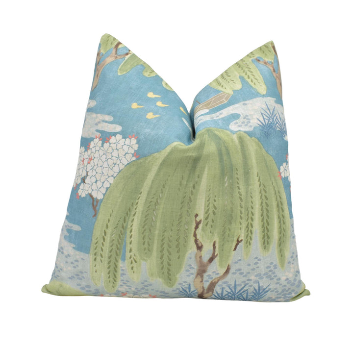 a decorative pillow with a tropical theme, including palm trees, flowers, and birds.