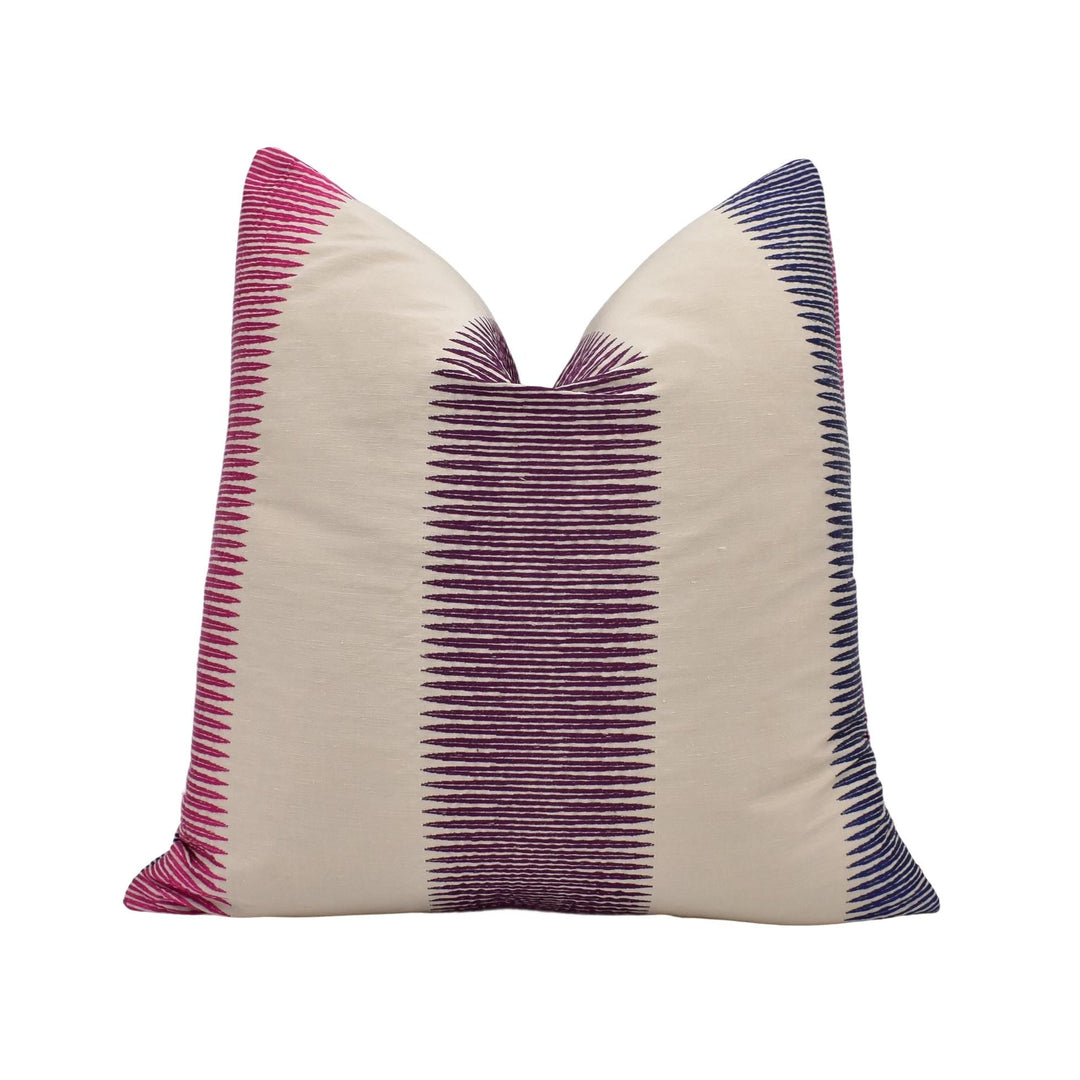 A single pillow with a striped pattern in pink and blue colors.