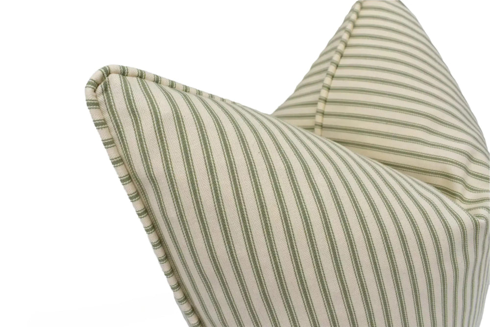 A close-up view of a striped cushion with a pointed top, featuring a repeating pattern of green and white stripes.