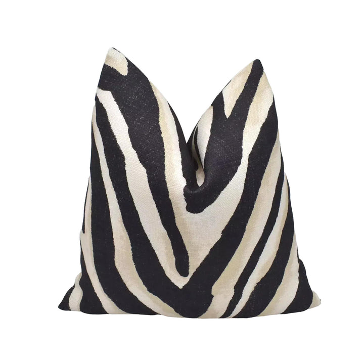 A black and white zebra print pillow is displayed against a white background.