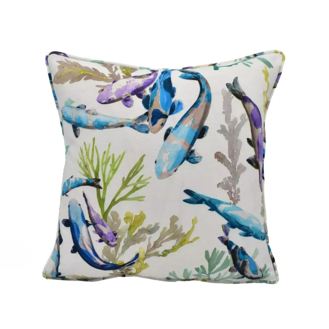 a white pillow with a vibrant, colorful print of fish and aquatic plants on it.