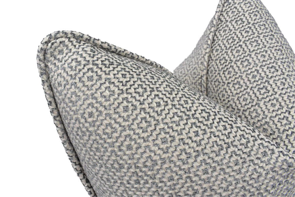 a close-up view of a gray and white patterned pillow, with a textured and woven appearance.