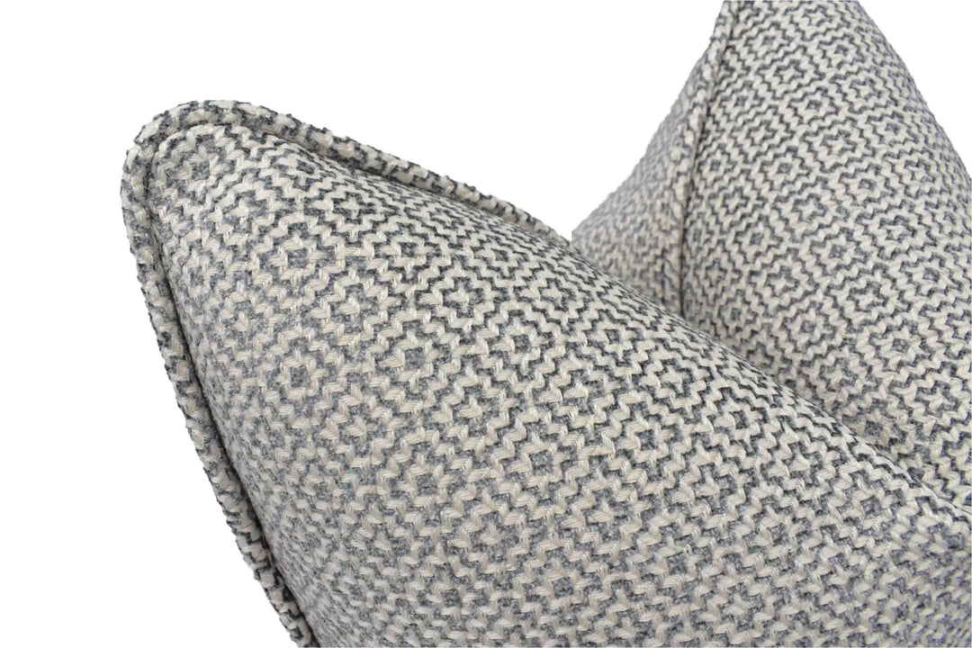 a close-up view of a gray and white patterned pillow, with a textured and woven appearance.