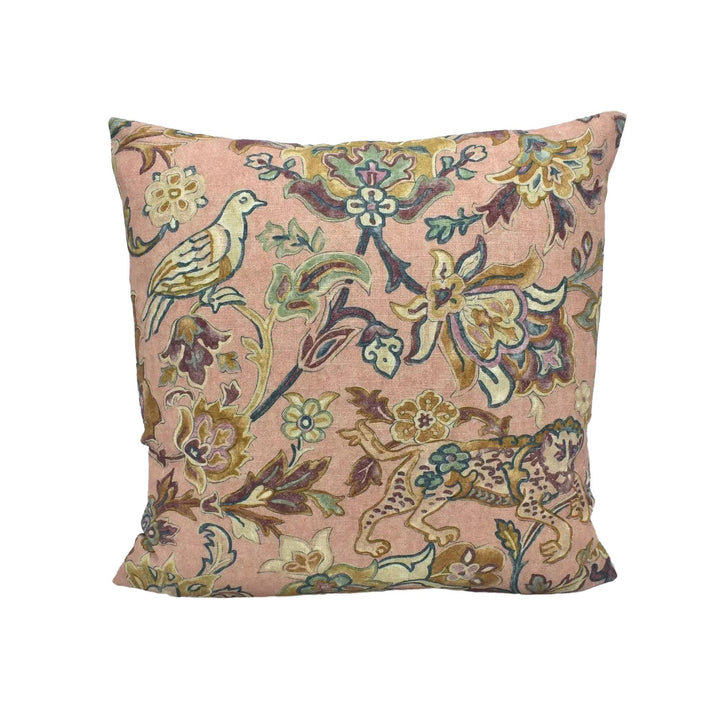 A decorative throw pillow with a floral pattern in shades of pink and green.