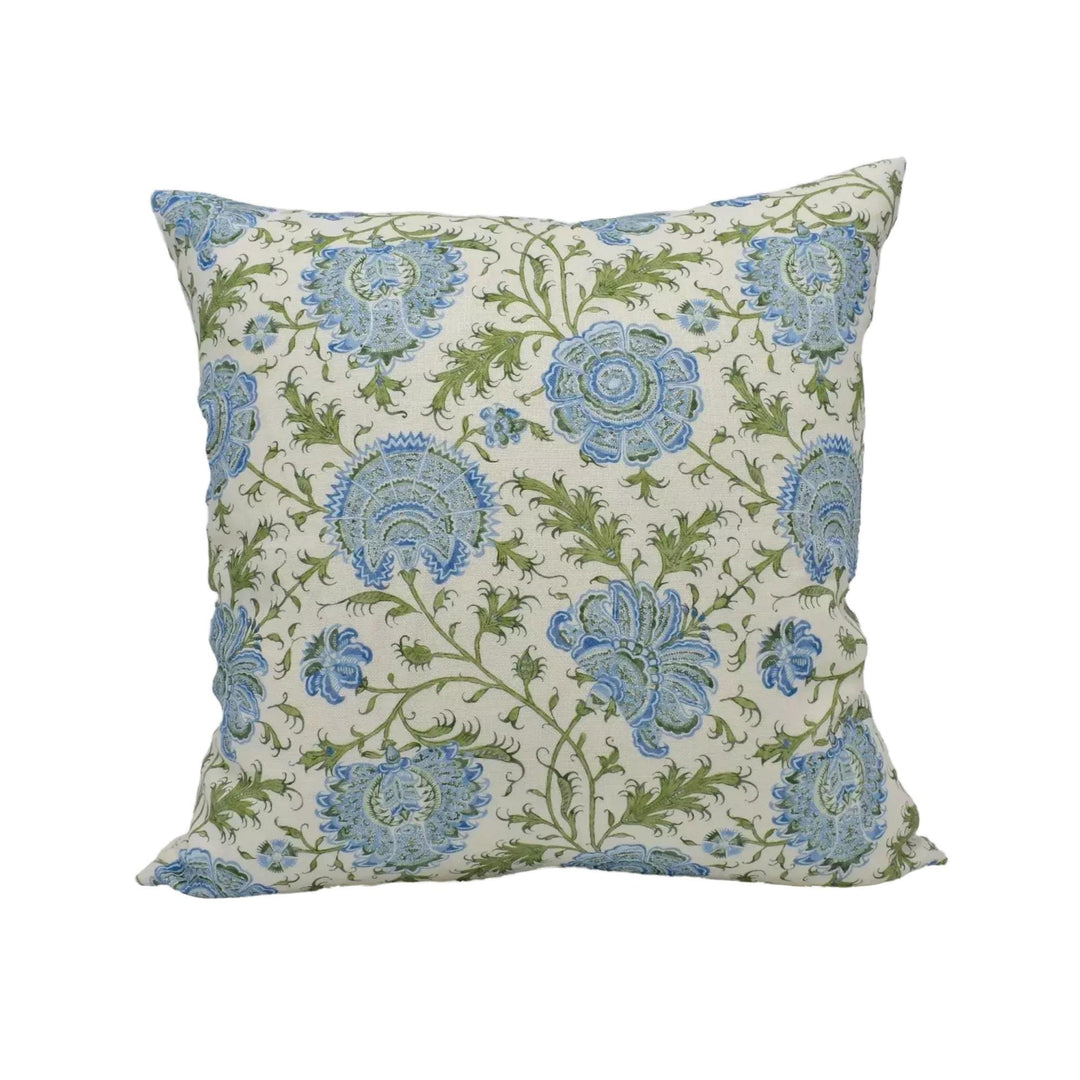 A square throw pillow with a floral pattern in shades of blue and green.