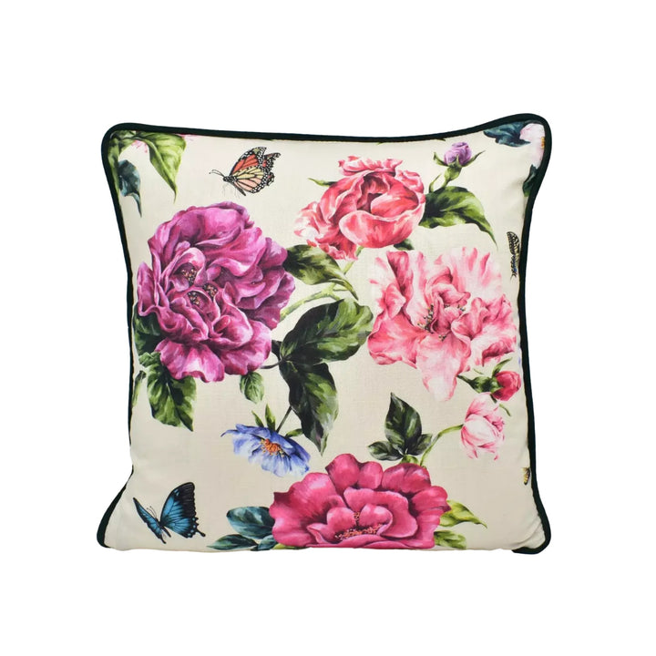 A decorative throw pillow with a floral pattern featuring pink and purple flowers, along with butterflies and leaves.