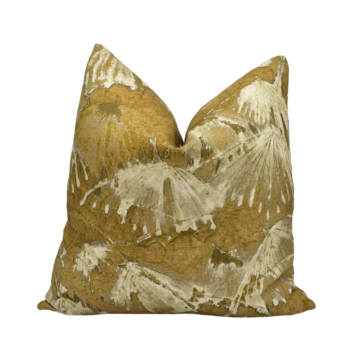a single pillow with a gold and white leaf pattern design.