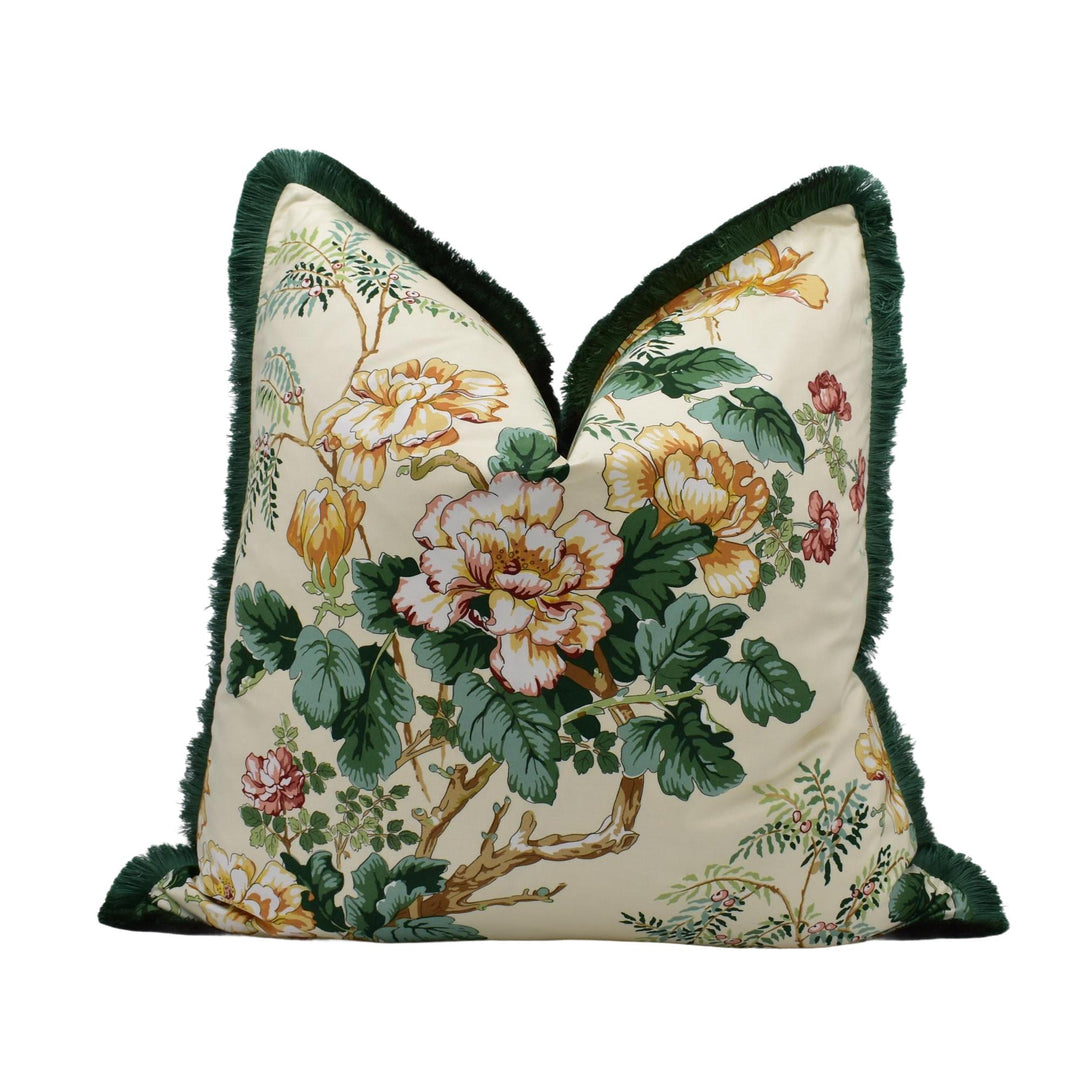 A decorative throw pillow with a floral print design in shades of green, yellow, and white.