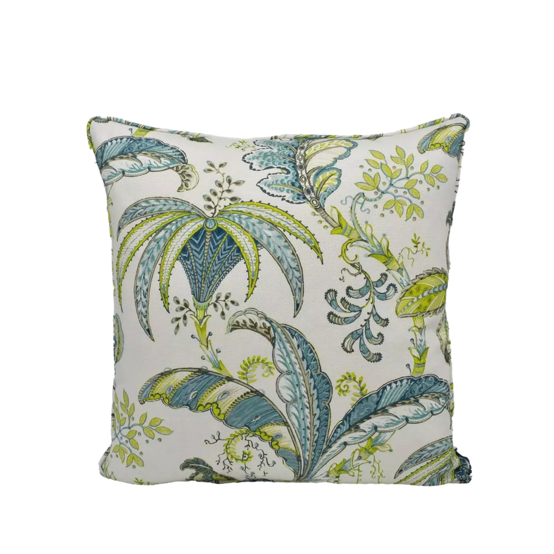 A decorative throw pillow with a tropical leaf pattern in shades of green and blue.