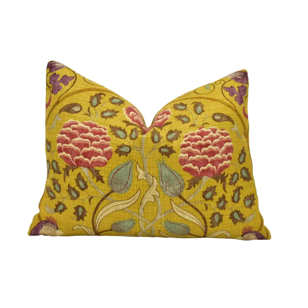 a decorative yellow pillow with a floral pattern.