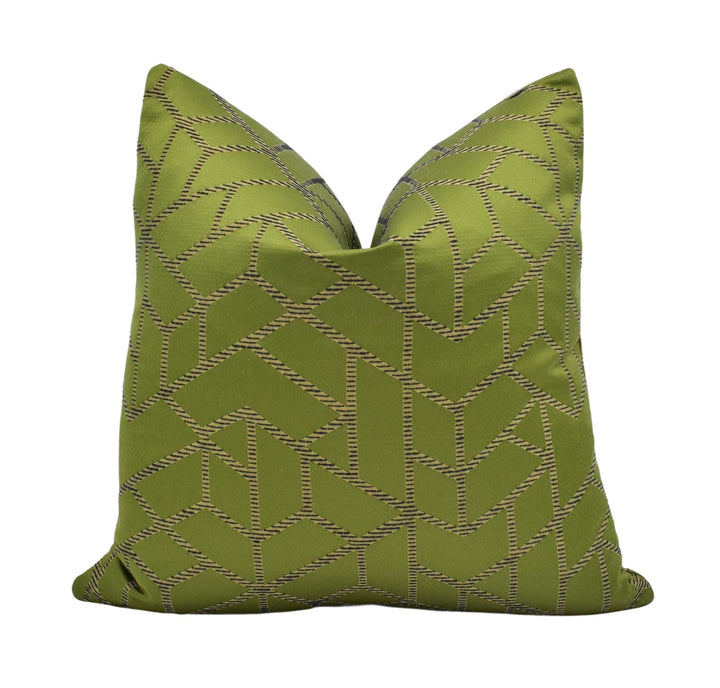 A green throw pillow with a geometric pattern.