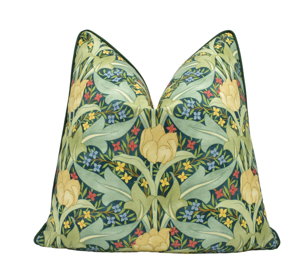 a green pillow with yellow and blue flowers on it