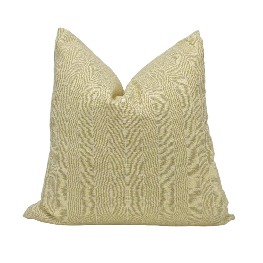 A single, square pillow with a striped pattern in a light yellow color.