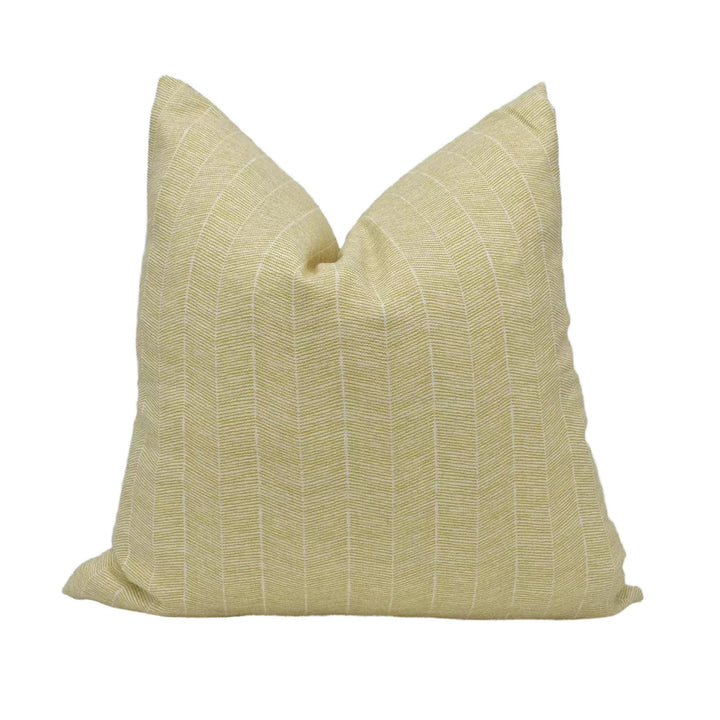 A single, square pillow with a striped pattern in a light yellow color.