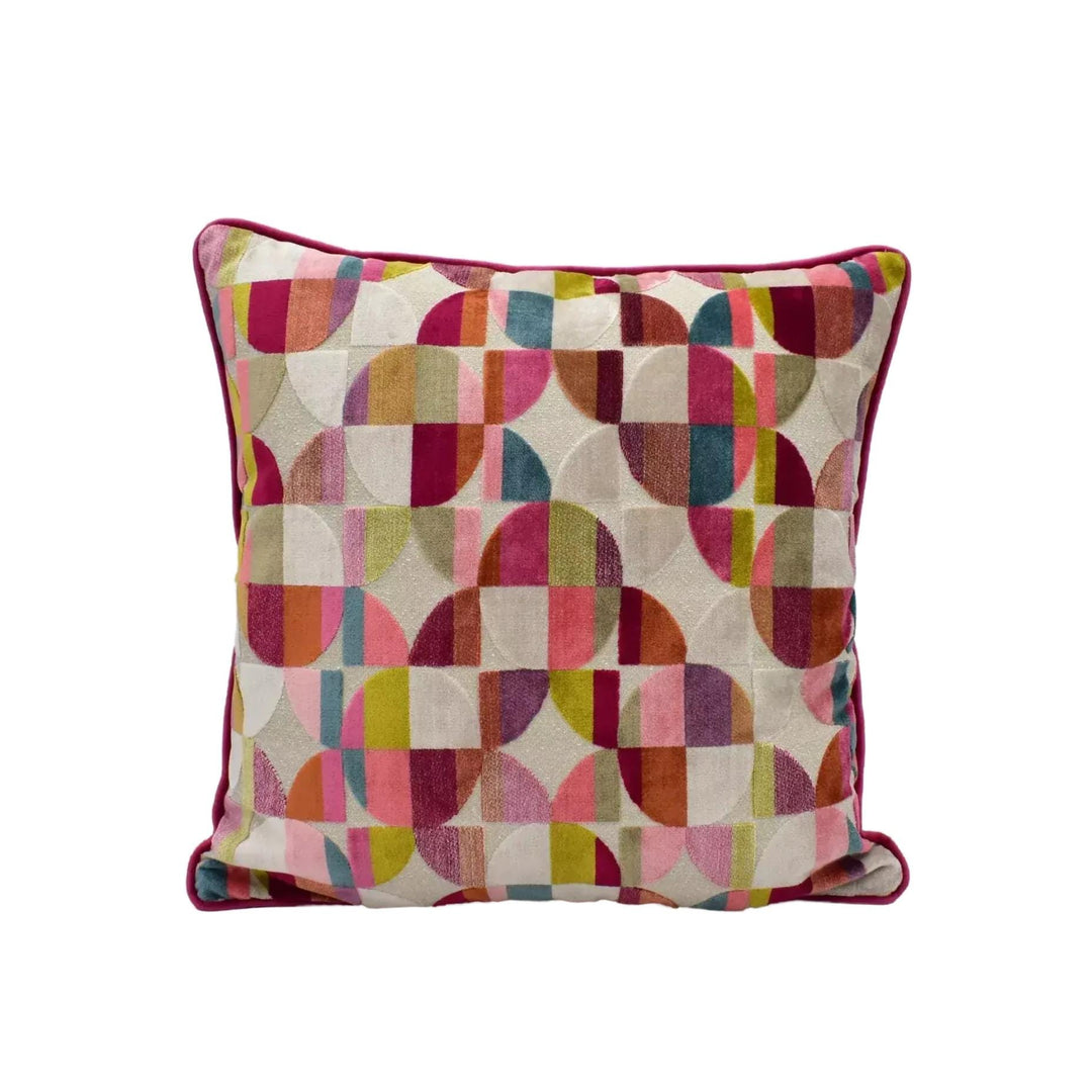 A square throw pillow with a vibrant geometric pattern in shades of pink, red, green, and yellow.