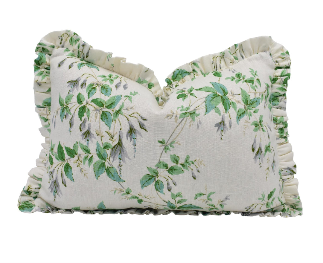 a white pillow with green leaves on it