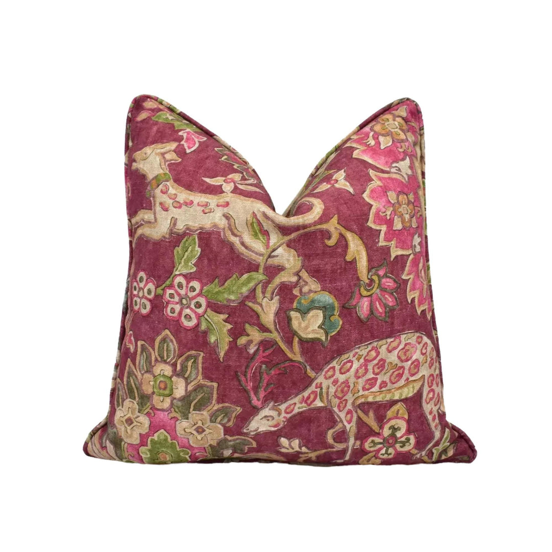 a decorative pillow with a vibrant floral pattern in shades of red, pink, and green.