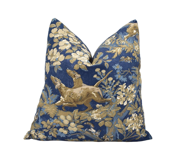 a decorative pillow with a floral pattern in shades of blue and gold.