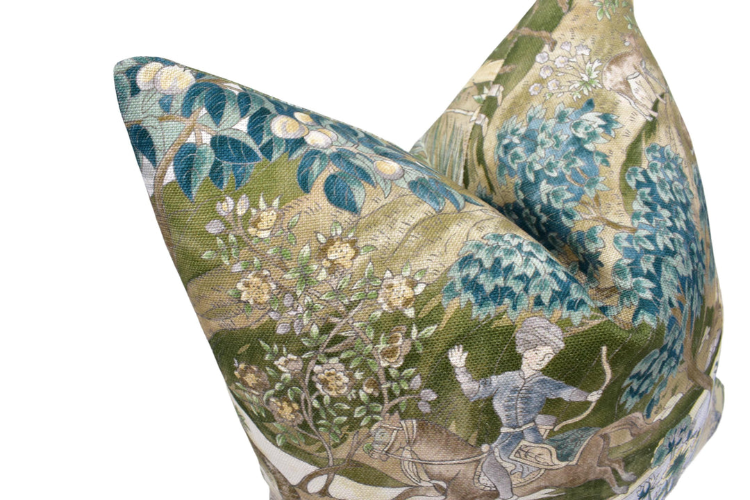 a close-up view of a decorative pillow with a detailed floral and nature-inspired design.