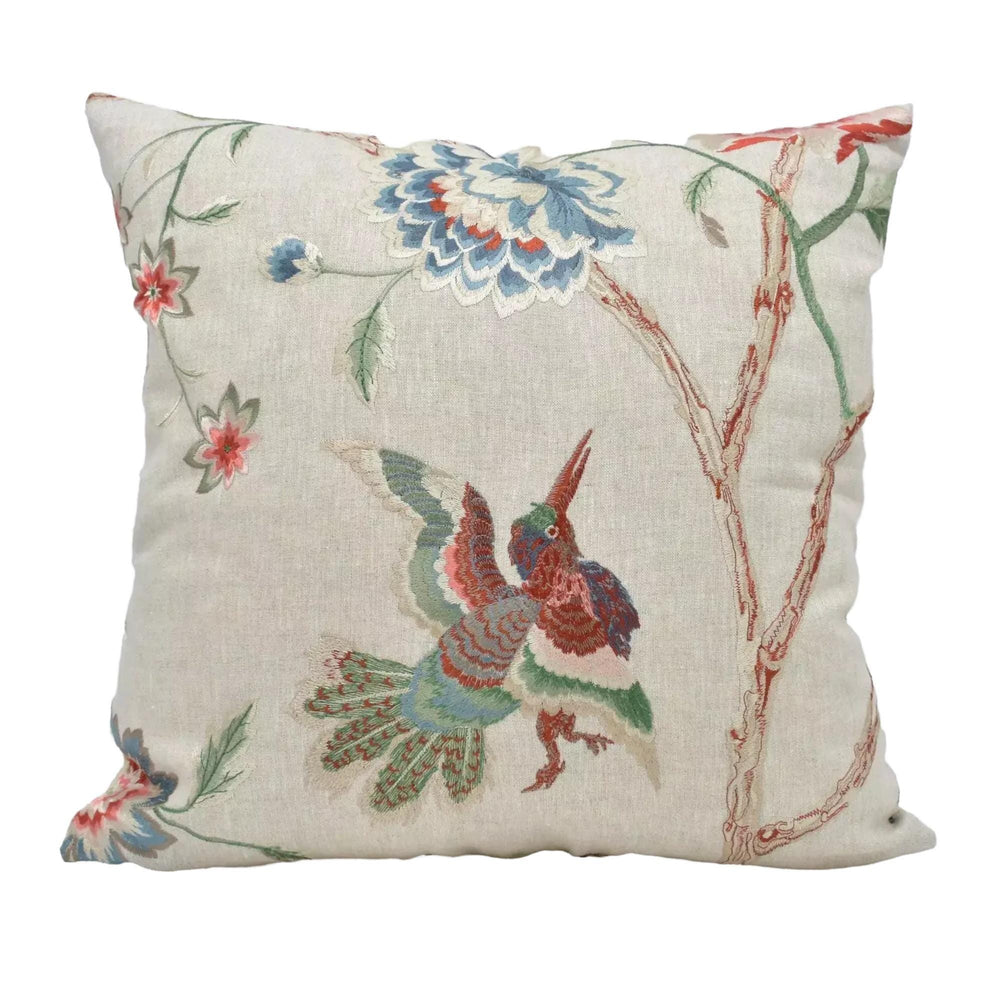 A decorative throw pillow with a floral and bird motif.