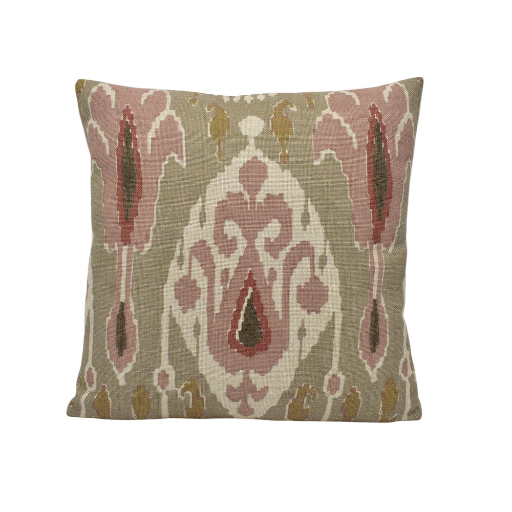 a pillow with a pink and green design on it