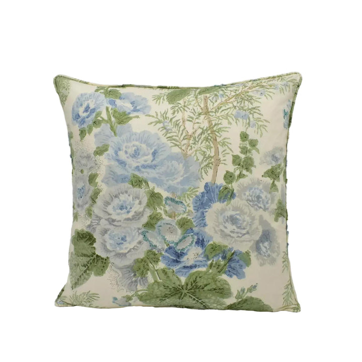 A square throw pillow with a floral print in shades of blue and green.