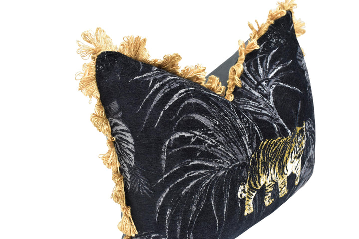 A close-up image of a black and gold patterned pillow with a tiger design.