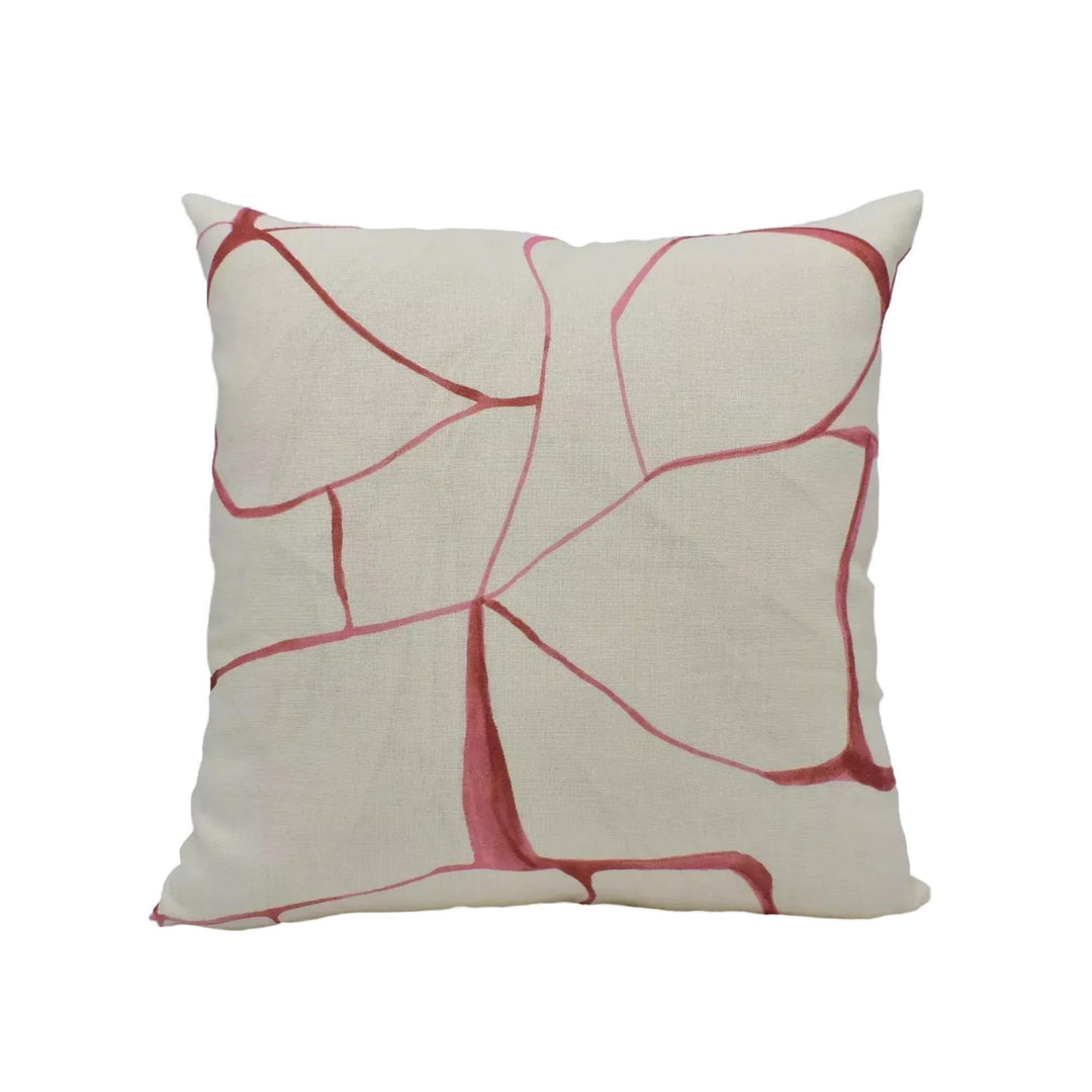 A square throw pillow with a white background and a red abstract pattern.