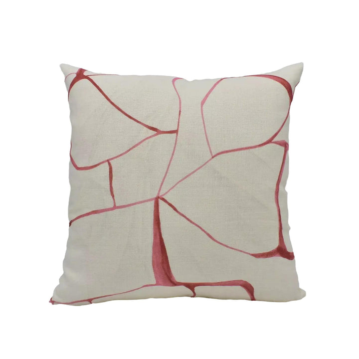 A square throw pillow with a white background and a red abstract pattern.