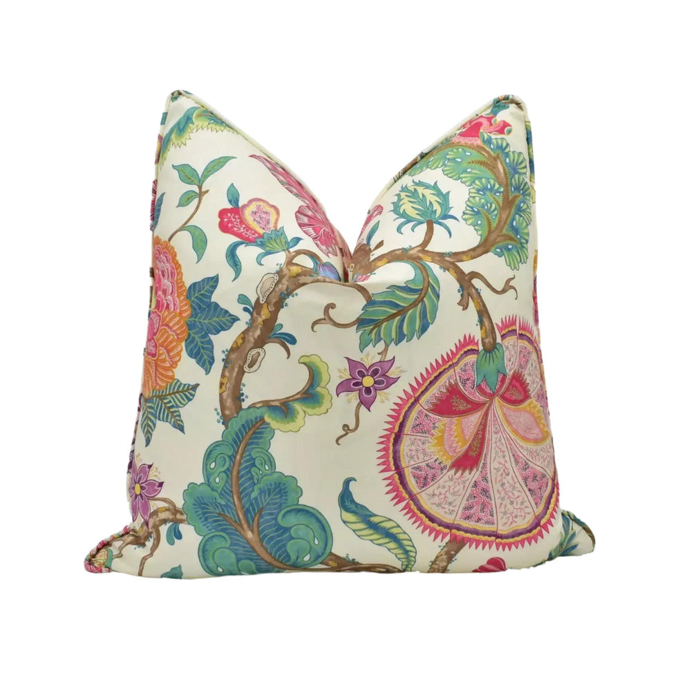a vibrant, colorful floral print pillow with a variety of flowers and leaves in shades of pink, green, and blue.