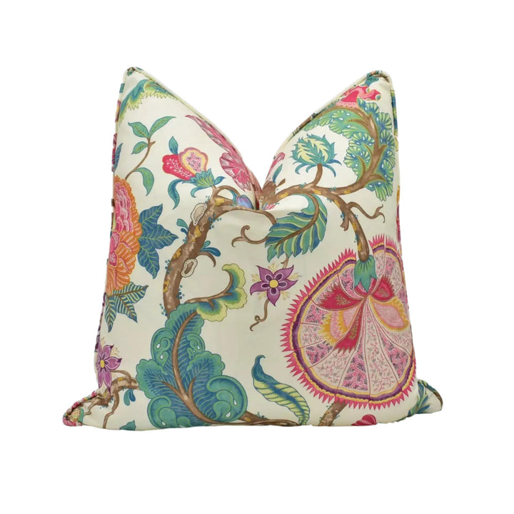 a vibrant, colorful floral print pillow with a variety of flowers and leaves in shades of pink, green, and blue.