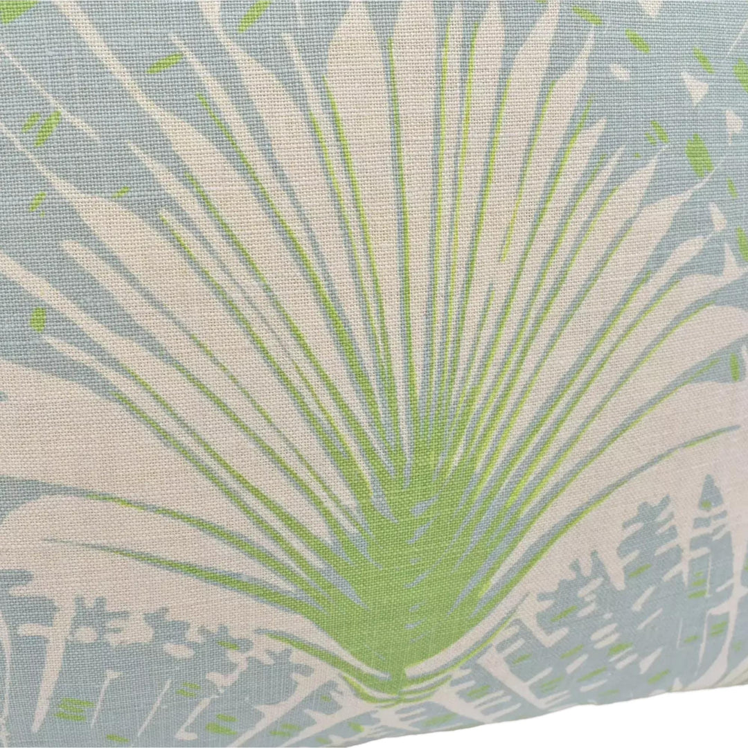 a close-up view of a fabric with a palm tree design in shades of green and white.
