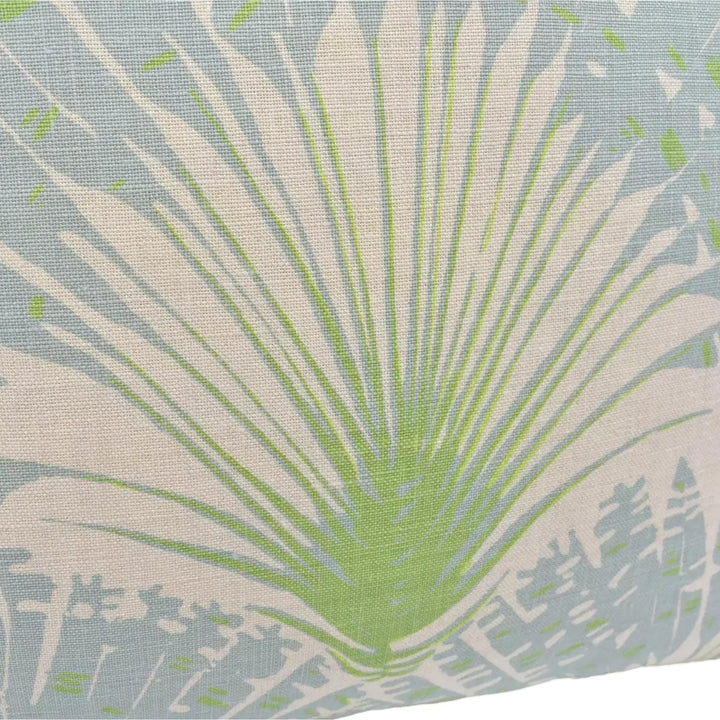 a close-up view of a fabric with a palm tree design in shades of green and white.