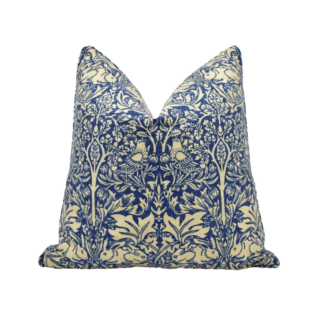A decorative pillow with a blue and white floral pattern.