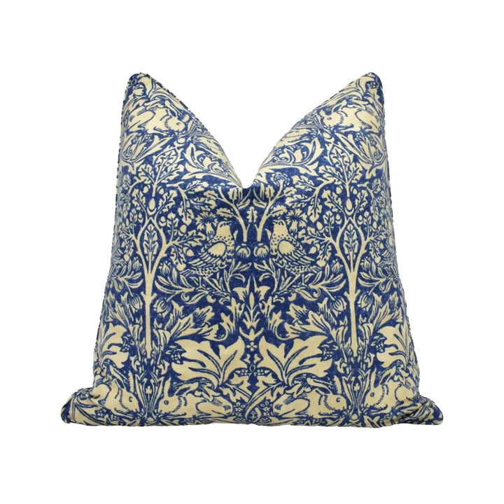 A decorative pillow with a blue and white floral pattern.