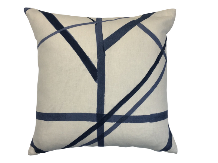 a white and blue pillow with lines on it