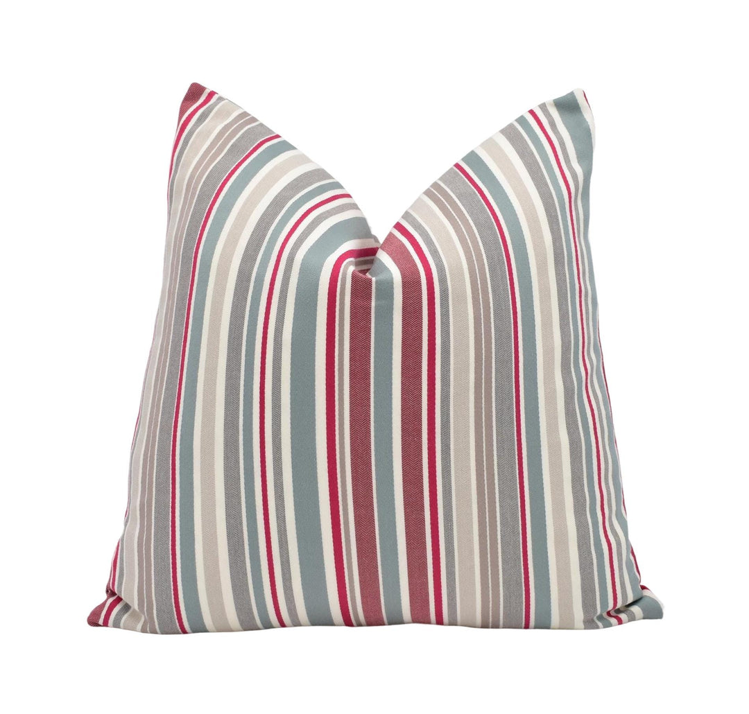 A single pillow with a striped pattern in shades of gray, red, and white.
