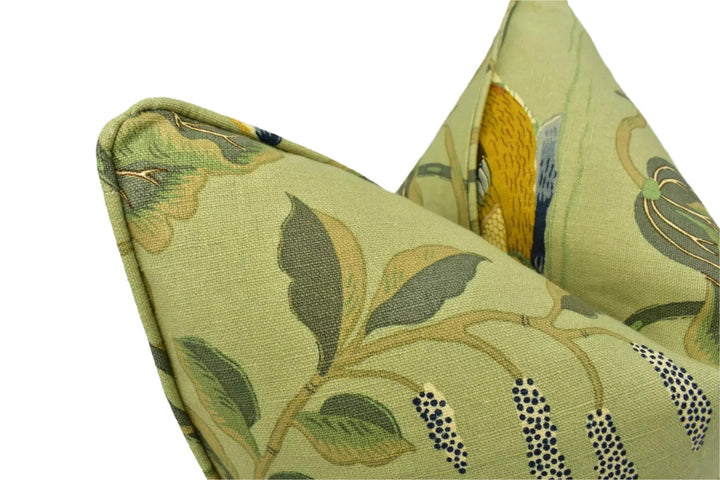 a close-up view of a green fabric with a leafy pattern and a bird design.
